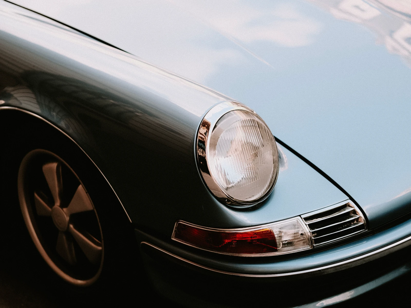 Close-up of a classic Porsche 911 headlight and front wing